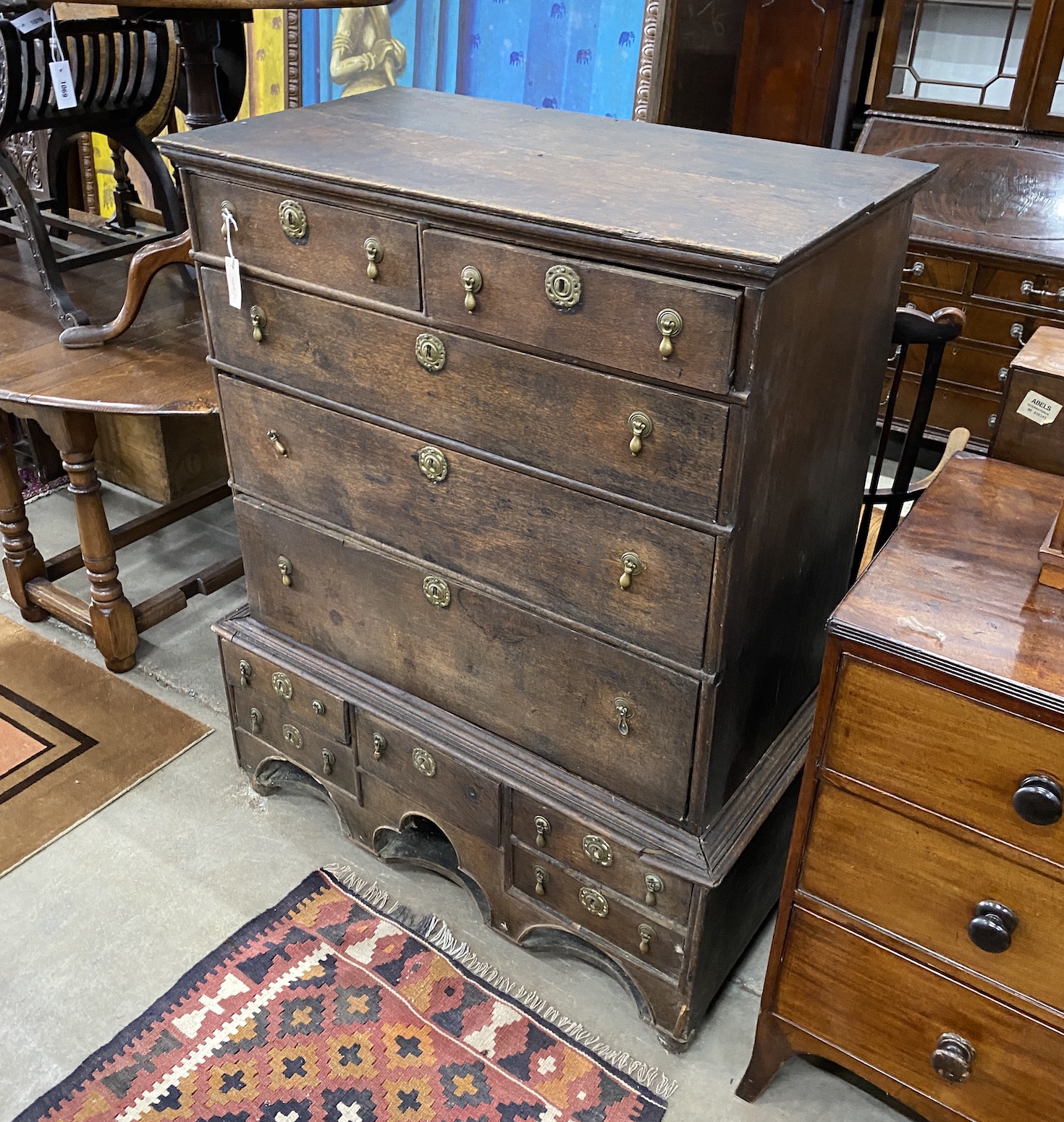 An 18th century oak chest on stand, width 102cm, depth 57cm, height 126cm